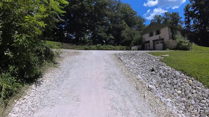The same driveway after recovery, with rock lining the edge
