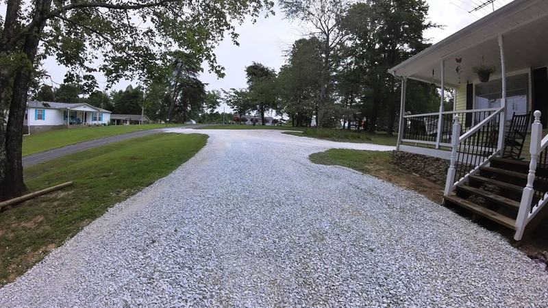 The same driveway after recovery, covered in fresh, packed gravel